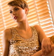 Photo: Woman and venetian blind Woman and venetian blind