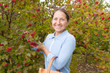 woman picking viburnum in the country