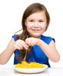 Little girl is eating spaghetti