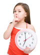 Little girl is holding big clock