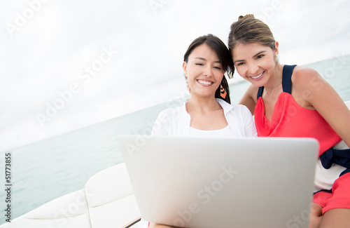 Photo: Women in a yacht with a laptop Women in a yacht with a laptop