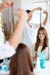 Happy woman cutting her hair