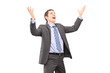 Young businessman with raised hands waiting something to fall