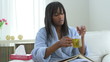 Sick African American woman drinking tea