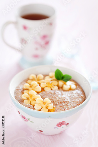 Photo: Oatmeal porridge with banana and flax seed, selective focus Oatmeal porridge with banana and flax seed, selective focus