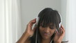 African American woman listening to music and laughing