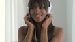 Excited African American woman listening to music and laughing