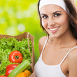 Photo: Woman in fitness wear with vegetarian food Woman in fitness wear with vegetarian food