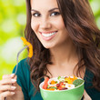 Young woman with salad, outdoors