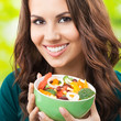 Young woman with salad, outdoors