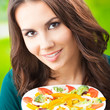 Young woman with salad, outdoors