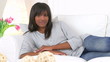 Casual black woman lounging on couch