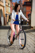 Urban biking - middle-age woman and bike in city