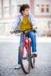 Photo: Urban biking - teenage boy and bike in city Urban biking - teenage boy and bike in city