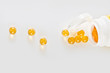 Capsules of fish oil spilled out open container