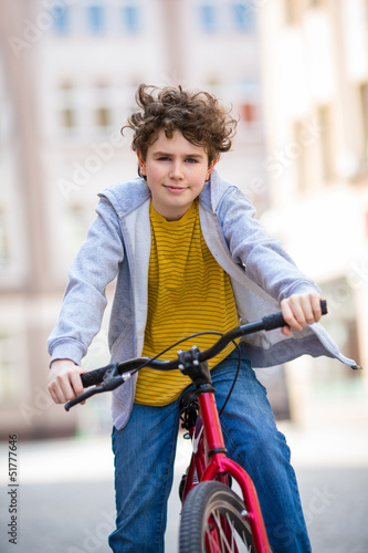 Photo: Urban biking - teenage boy and bike in city Urban biking - teenage boy and bike in city