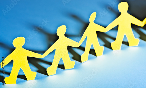 Photo: Paper people in teamworking concept Paper people in teamworking concept