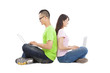 young  couple sitting together with laptop