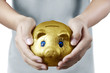 Photo: putting coin into piggy bank in hand putting coin into piggy bank in hand