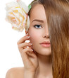 Beauty Girl. Beautiful Model with Rose Flower Touching her Face