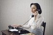 Photo: Woman talking on phone at desk Woman talking on phone at desk