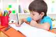 Photo: Cute little boy drawing in his album Cute little boy drawing in his album