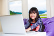 Photo: Little asian girl with computer at home Little asian girl with computer at home