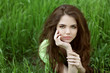 Young brunette woman on the green field grass, outdoors portrait