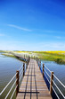 Wooden bridge into the lake of Alqueva , Portugal