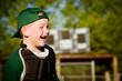 Photo: Portrait of child in catcher's gear laughing while playing Portrait of child in catcher's gear laughing while playing