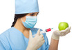 Chemist with syringe and apple