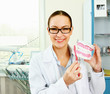 Portrait of handsome young dentist teaching