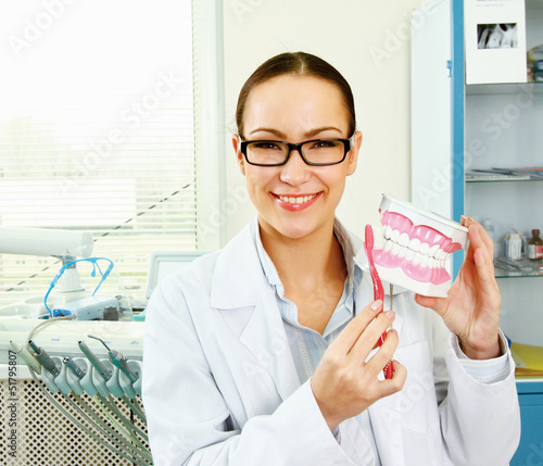 Photo: Portrait of handsome young dentist teaching Portrait of handsome young dentist teaching