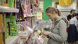 Young woman is choosing toys for her kid.