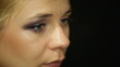 Detail of a young woman applying eye shadow makeup with cosmetic