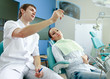 Young woman with dentist in a dental surgery