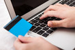 Person Using Credit Card For Online Shopping