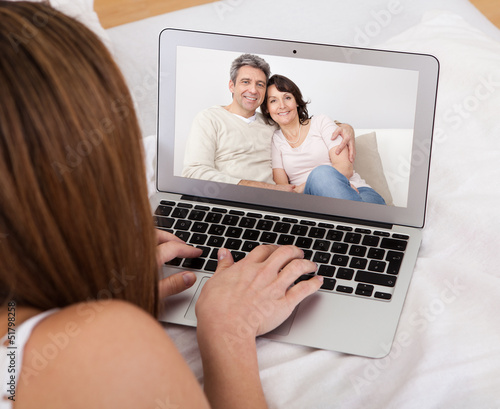 Photo: Young Woman Video Chatting Young Woman Video Chatting