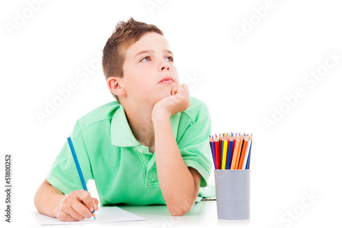 Photo: Dreaming boy lying on the floor and drawing with colorful pencil Dreaming boy lying on the floor and drawing with colorful pencil