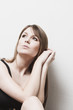 Pensive woman sitting thinking