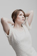 Young woman standing daydreaming
