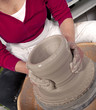 Potter's hands shaping clay