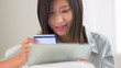 Chinese woman making a purchase on a tablet