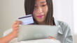 Chinese woman making a purchase on a tablet