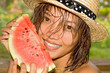 Young woman holding a fresh water melon.