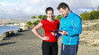 Young woman and personal trainer with tablet computer, slow moti