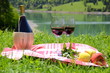 Photo: Wine and fruits served at a picnic in Alpine meadow. Switzerland Wine and fruits served at a picnic in Alpine meadow. Switzerland