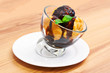 Profiteroles with chocolate sauce in a glass bowl