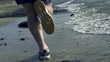 Young man jogging on the beach, slow motion shot at 120fps 
