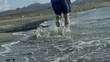 Young man jogging on the beach, slow motion shot at 60fps 
